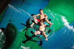 Two boys on a tube on a waterslide