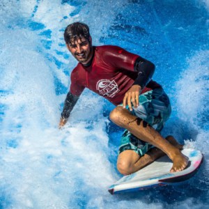 man riding surfboard in the FlowRider attraction