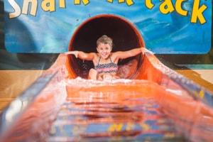 Girl at the end of a waterslide