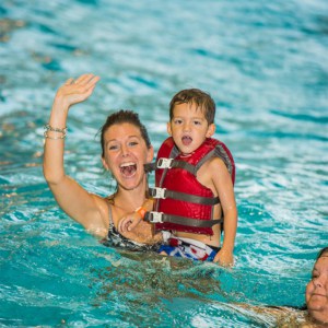 Mom and child in the water wearing a life jacket