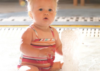 Baby sitting in kiddie pool