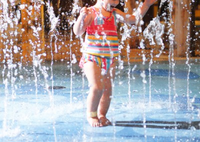Toddler enjoying the water spouts