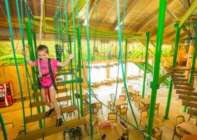 Girl climbing on Tree Tops Ropes Course