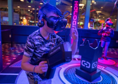 Boy playing Hologate VR holding gun prop
