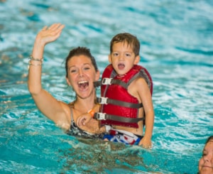 Mom and child in the water wearing a life jacket