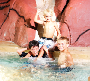 Three boys sitting in hot tub