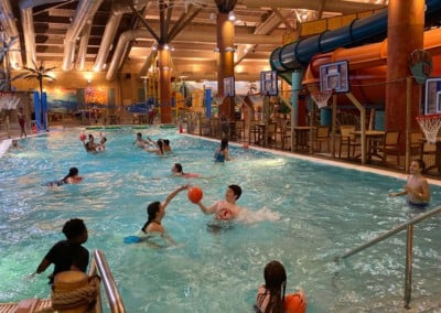 kids playing with basketballs in a pool: adventure bay