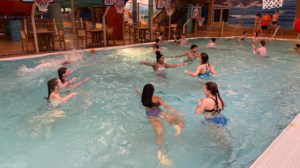 kids playing with basketballs in a pool: adventure bay