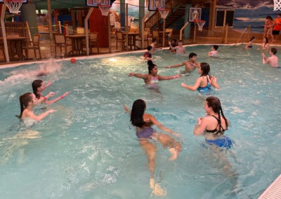 kids playing with basketballs in a pool: adventure bay