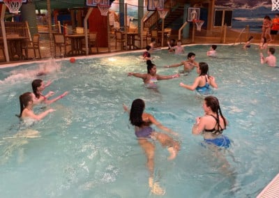 kids playing with basketballs in a pool: adventure bay