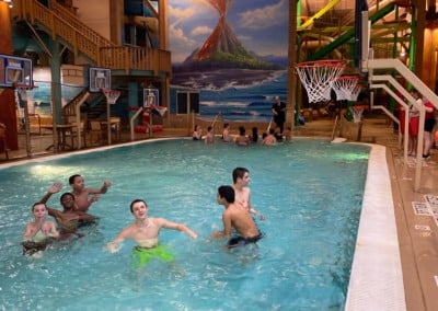 kids playing in a pool with basketballs: adventure bay