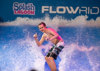 kid riding a surfboard in the FlowRider