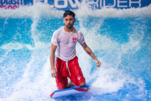 lifeguard riding surfboard in the FlowRider