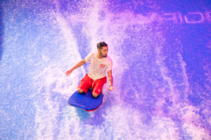 lifeguard riding surfboard on the FlowRider