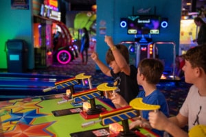 kid cheering after winning in an arcade game